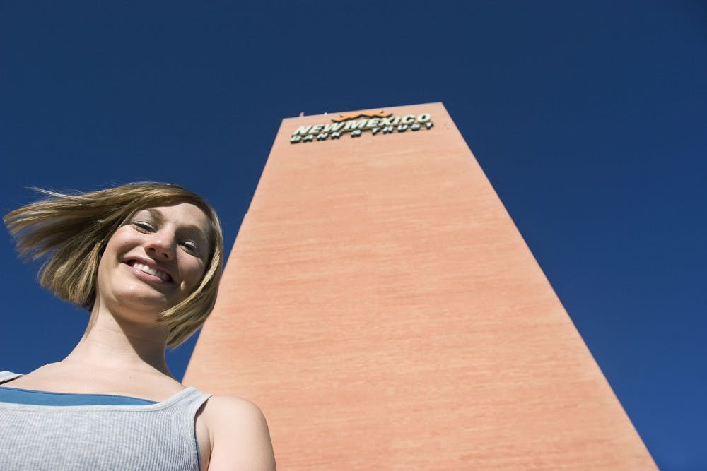 	Student Kari Harnick stands in front of the New Mexico Bank &amp; Trust building downtown. Harnick will rappel down the building’s face Sept. 25 to fundraise for the New Mexico Special Olympics.