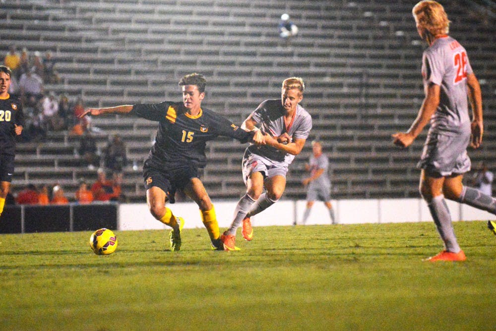 Forward Sam Gleadle fights off a SFU player during their game Thursday Sept. 30, 2015. The Lobos beat out SFU 3-0.