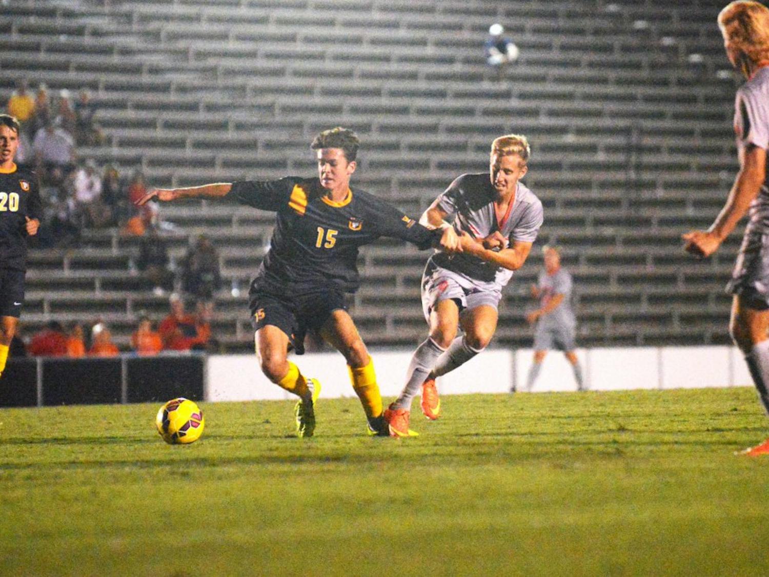Forward Sam Gleadle fights off a SFU player during their game Thursday Sept. 30, 2015. The Lobos beat out SFU 3-0.