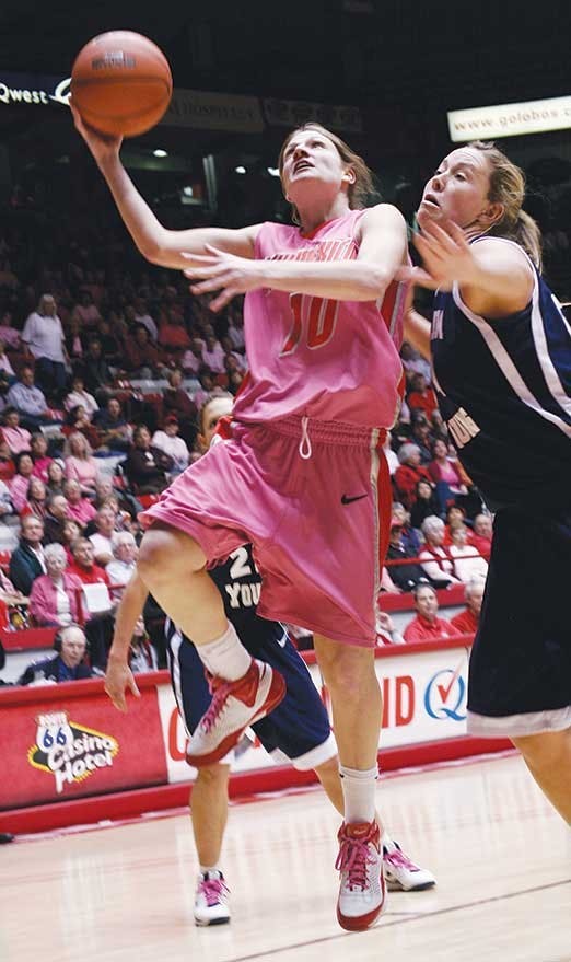 Amy Beggin goes up for a layup over BYU's  Cassie King on Tuesday at The Pit.  The Lobos cruised to a 52-37 win.