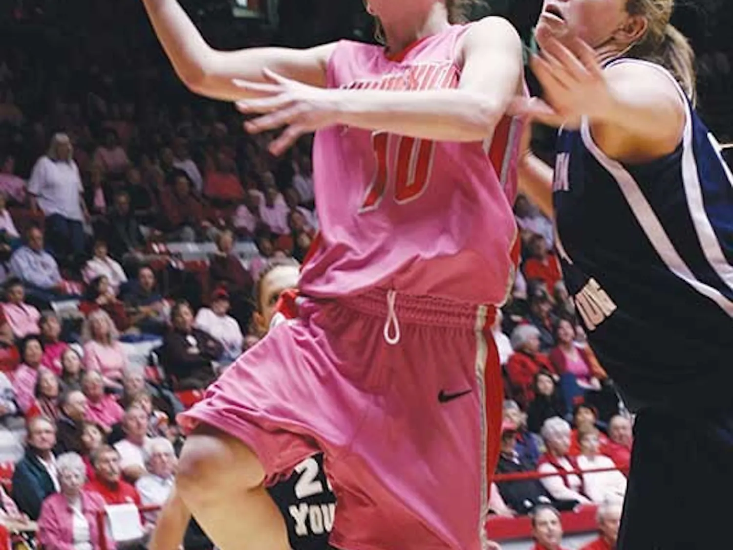 Amy Beggin goes up for a layup over BYU's Cassie King on Tuesday at The Pit. The Lobos cruised to a 52-37 win.