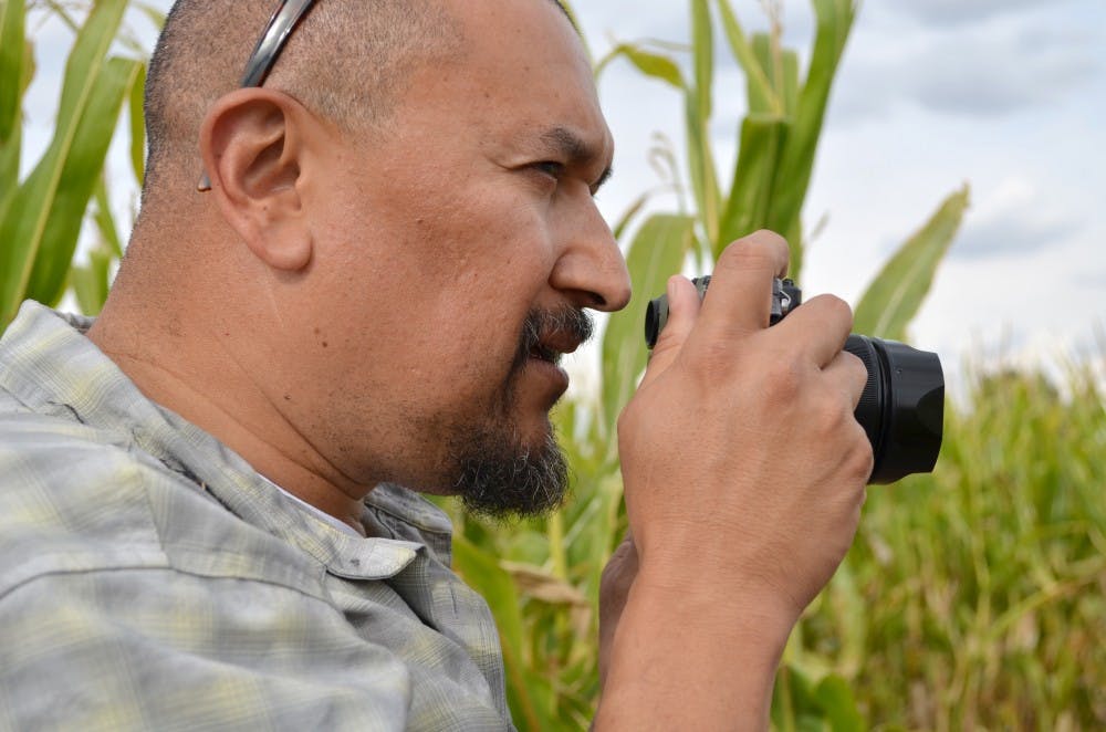 	Rosales composes a shot of the Maize Maze for the Albuquerque Journal. He has been working for the paper for 12 years. 