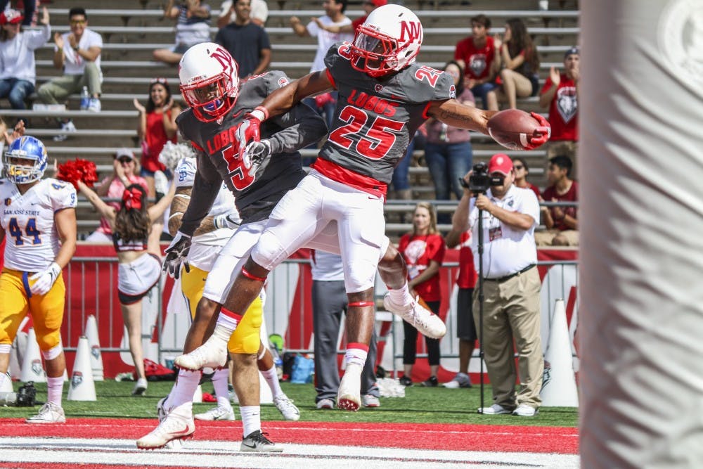Wide receiver Patrick Reed, 5, and running back Tyrone Owens celebrate in the Lobo end zone after a touchdown Saturday Nov. 1, 2016. The Lobos defeated San Jose State 48-41.