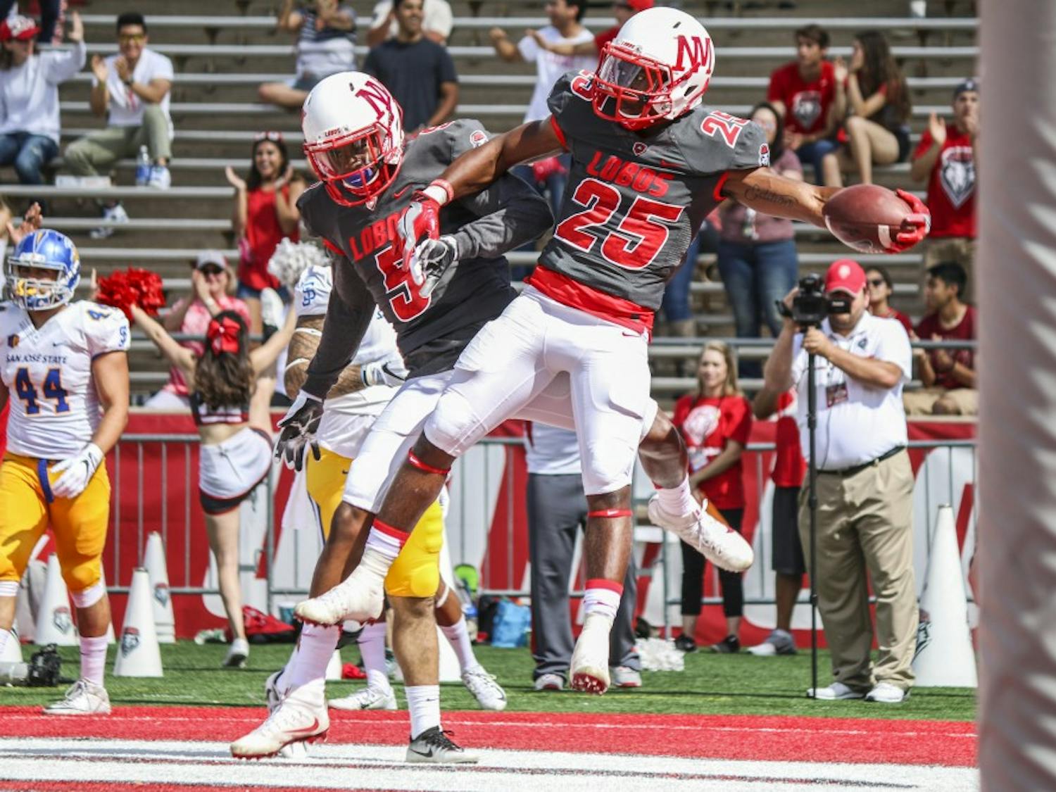 Wide receiver Patrick Reed, 5, and running back Tyrone Owens celebrate in the Lobo end zone after a touchdown Saturday Nov. 1, 2016. The Lobos defeated San Jose State 48-41.