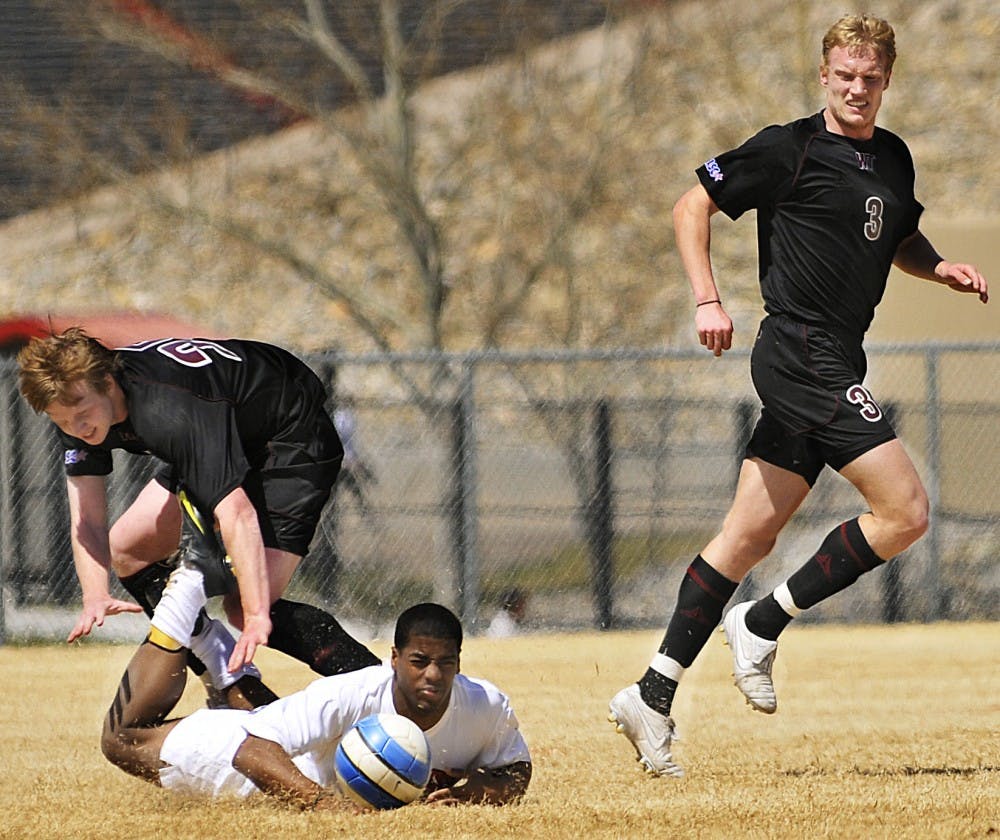 	Michael Green , center, tumbles to the field as West Texas A&amp;M’s Nicki Nielsen, right, pursues the ball during the Lobos’ scrimmage on Saturday
at Robertson Field