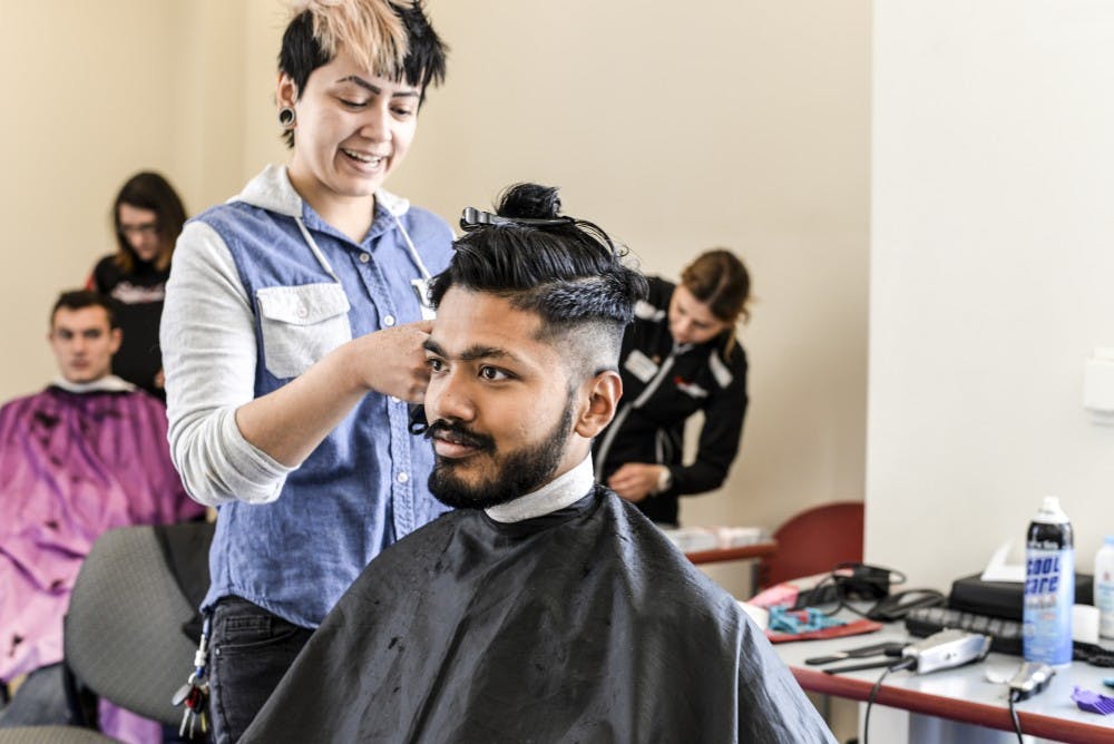 Shulav Rawal sits to get a free haircut on April 13, 2018 during the Shear Empowerment event to raise awareness for and pledge to end sexual assault on campus.