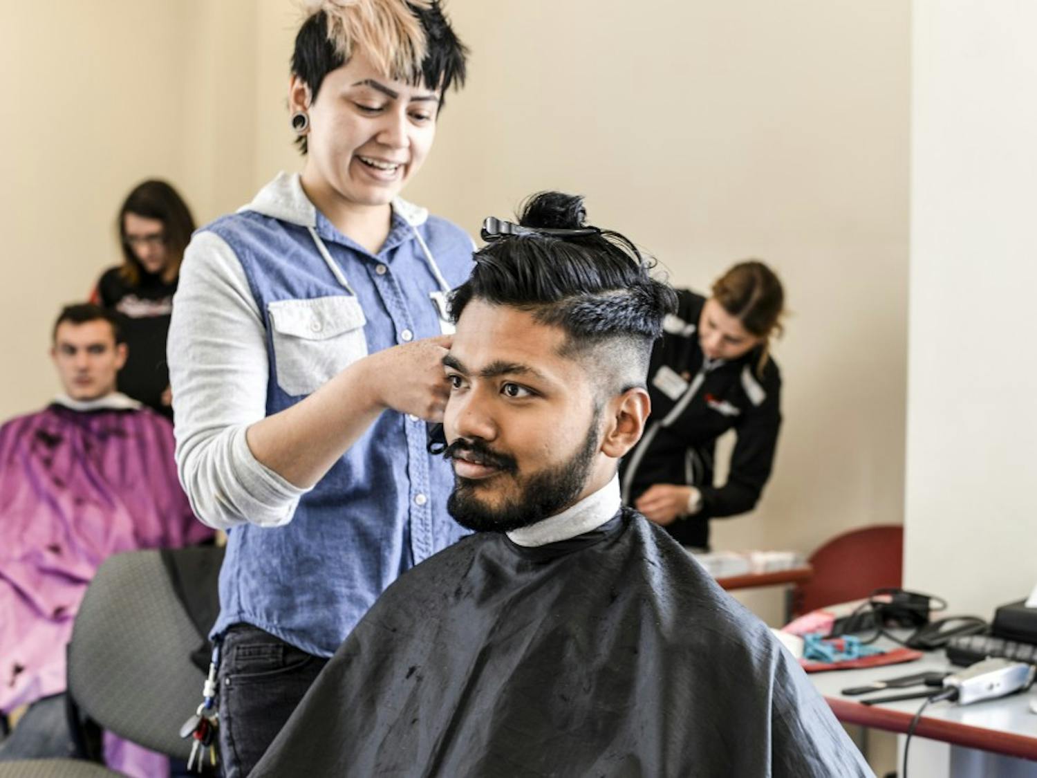 Shulav Rawal sits to get a free haircut on April 13, 2018 during the Shear Empowerment event to raise awareness for and pledge to end sexual assault on campus.