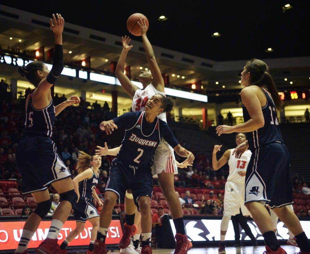Redshirt junior center Whitney Johnson&nbsp;leaps through Duquesne's defense on her way to the net at WisePies Arena Saturday night. The Lobos are scheduled to play UTEP Dec. 2 in El Paso, Texas.&nbsp;