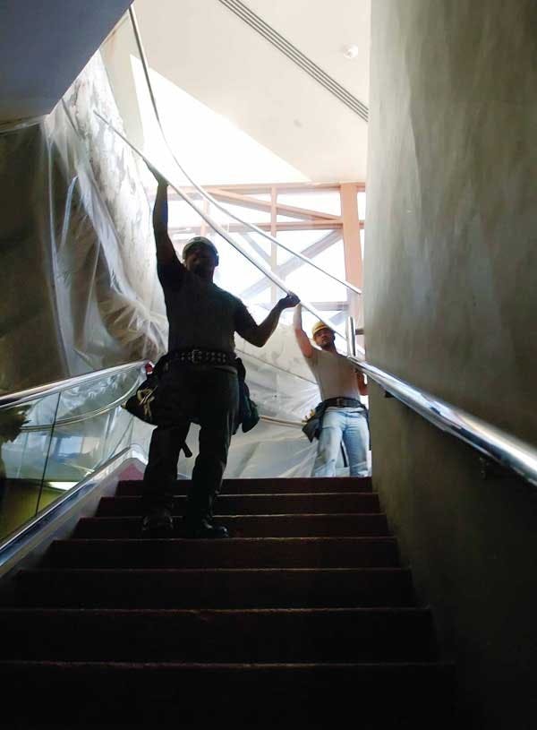 Marcus Santos and Kris Robertson move sheet rock into Centennial Science and Engineering Library on Tuesday. Workers are blocking off the main entrance for remodeling.