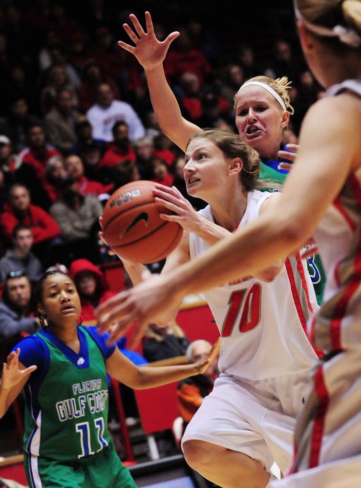 	In this file photo, Amy Beggin slices between multiple Florida Gulf Coast defenders on the way to the basket. UNM travels to Las Cruces to face the Aggies today.
