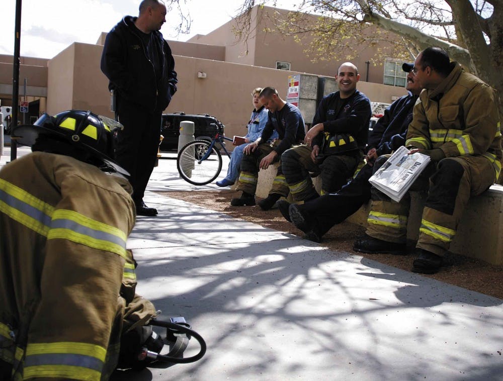 Albuquerque Fire Department firefighters wait for Popejoy Hall to be cleared by a UNMPD K-9 unit after a bomb threat was called in Thursday. The SUB and Popejoy Hall were evacuated for one hour. 