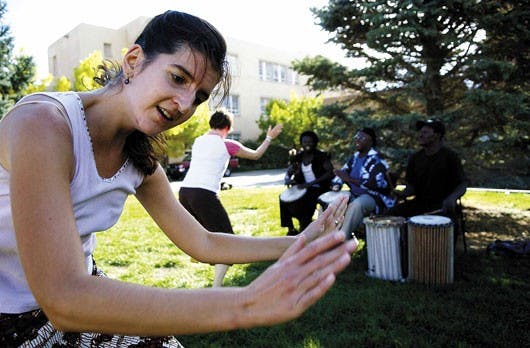 Mary Nakigan, front, dances with the Casadimanza dance troupe in front of Carlisle Gym on Wednesday.  