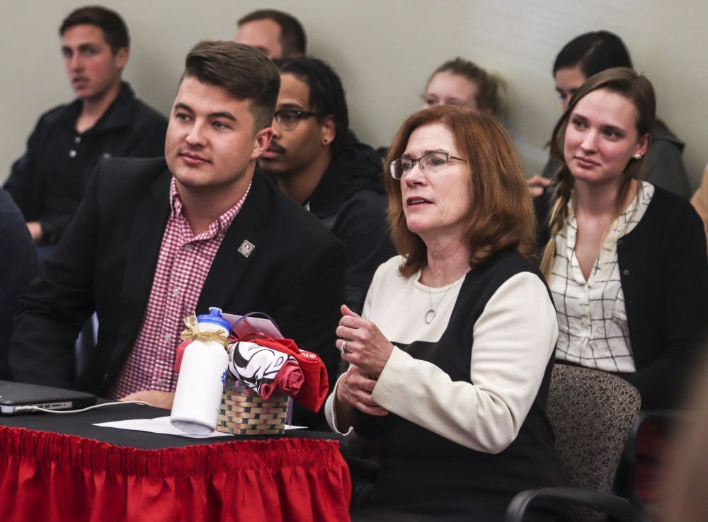 New UNM President Garnett S. Stokes sits with ASUNM President Noah Brooks after receiving a gift basket during her “listening tour” at the ASUNM meeting on the evening of March 28, 2018.