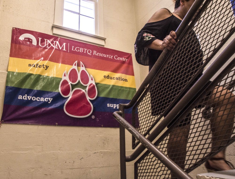 An LGBTQ Resource Center employee climbs the stairs of the facility after a tabling event during UNM's Welcome Back Days on Wednesday.