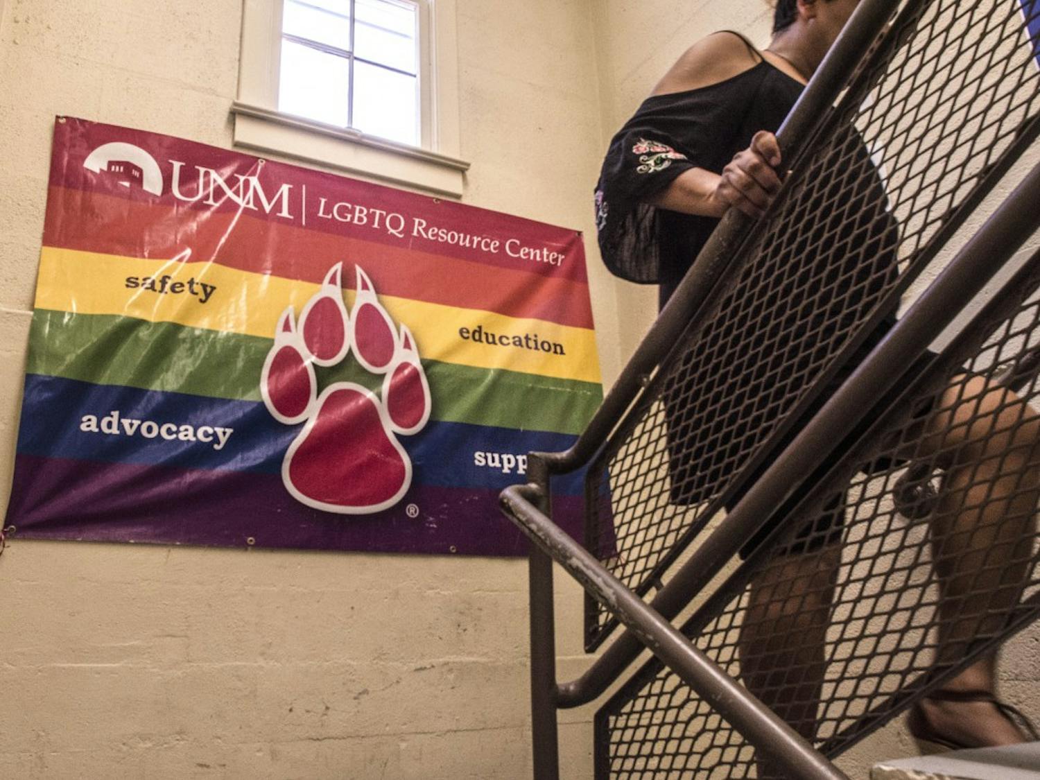 An LGBTQ Resource Center employee climbs the stairs of the facility after a tabling event during UNM's Welcome Back Days on Wednesday.