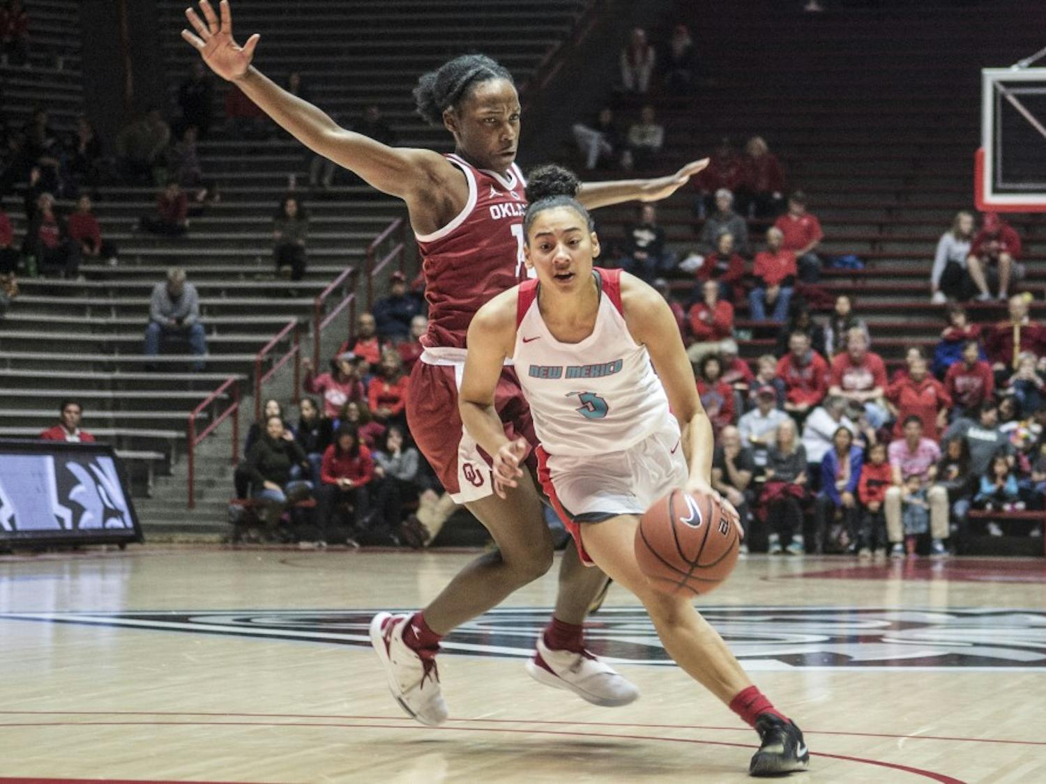 Ahlise Hurst drives to the basket past Shaina Pellington during the second half of Wednesday’s game at Dreamstyle Arena. Hurst scored 39 points to set a new freshman scoring record to lead the Lobos to an 84-80 victory.