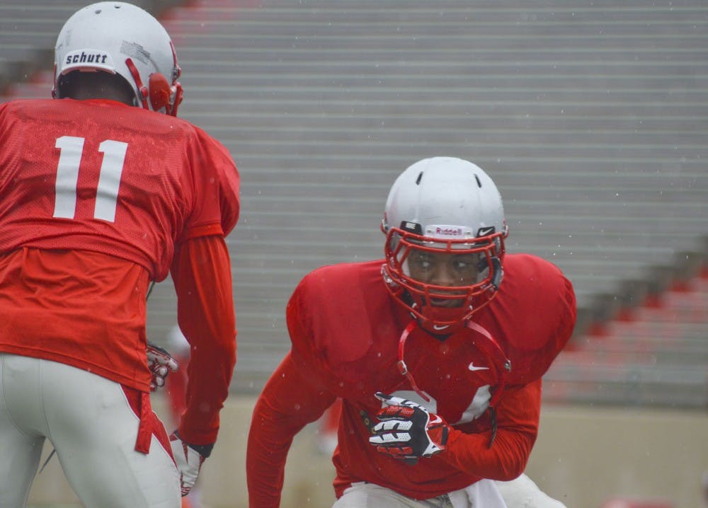 	Lobo junior wide receiver Carlos Wiggins, right, works on drills during a football practice at University Stadium on Friday morning. The Lobos will open their season playing against UTEP on Saturday night.