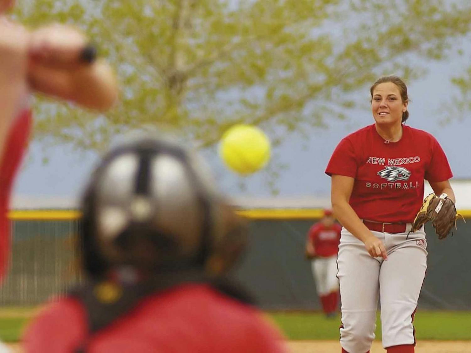 Pitcher Tori Rogers throws to catcher Liz Young during practice at Lobo Field on Wednesday.