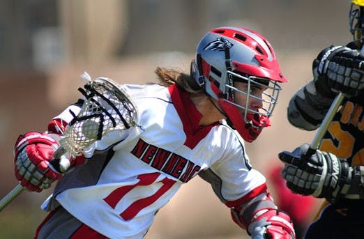 Midfielder Marcos Rivera tries to claim the ball over Northern Arizona's Lon Giancola. Both teams compete in the Rocky Mountain Lacrosse Conference.