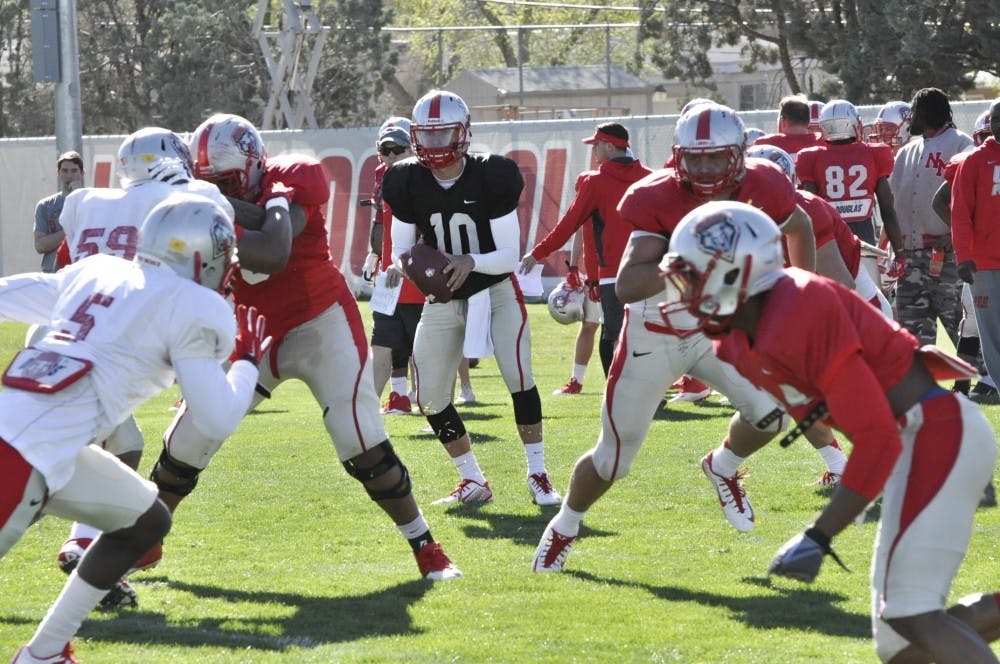 Quarterback Austin Apodaca takes a snap during spring football practice at the Tow Diehm Complex on March 27. Apodaca turned down an invitation to visit UNM for a recruiting trip out because of a commitment to Washington State. He later transferred to a junior college and now has joined the Lobos. For more, see Page 16.