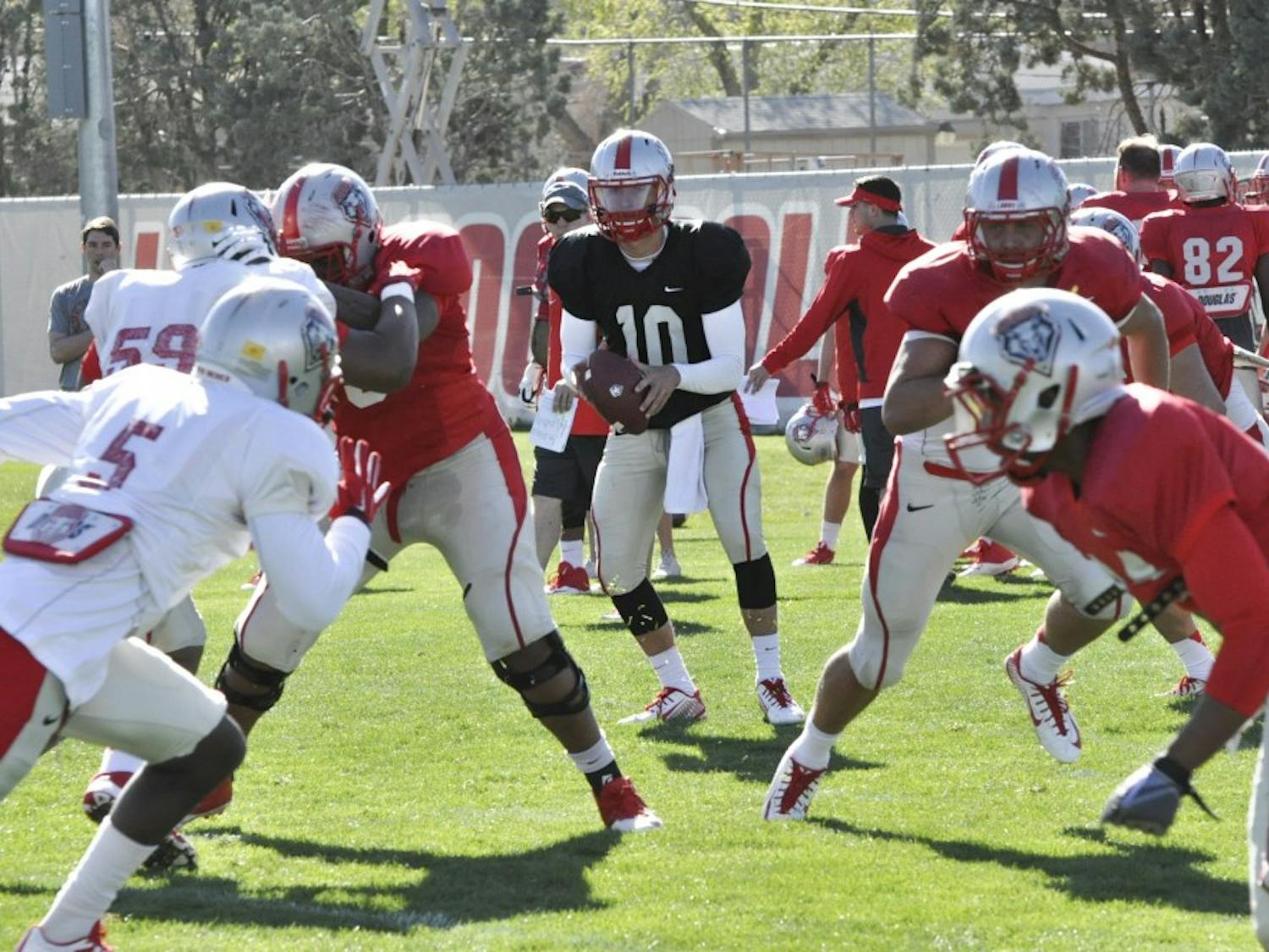 Quarterback Austin Apodaca takes a snap during spring football practice at the Tow Diehm Complex on March 27. Apodaca turned down an invitation to visit UNM for a recruiting trip out because of a commitment to Washington State. He later transferred to a junior college and now has joined the Lobos. For more, see Page 16.
