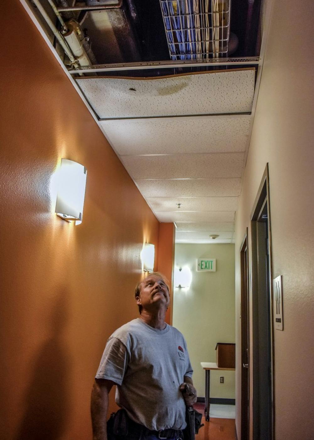 Dennis Roberts, a plumber with Area Four in Facilities and Management, surveys the water damage.