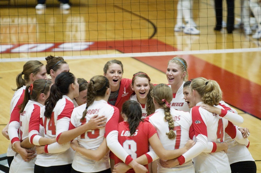 	Rose Morris, center in red jacket, cheers with her teammates before a volleyball match against TCU at Johnson Gym on Wednesday. Morris didn’t play in Wednesday’s match, and it’s unclear when she’ll return to the court.