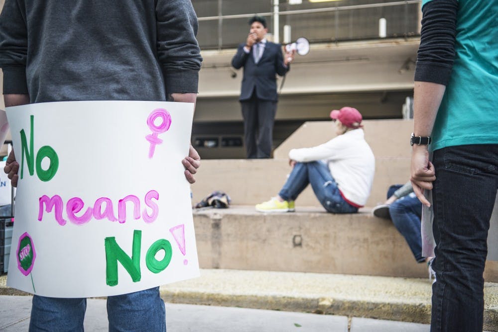 Frankie Flores, a staff member from the UNM LGBTQ Resource Center, speaks to event supporters outside of the Cornell parking garage on Thursday. The Student Alliance for Reproductive Justice organized the Take Back The Night event in solidarity with Sexual Assault Awareness Month.