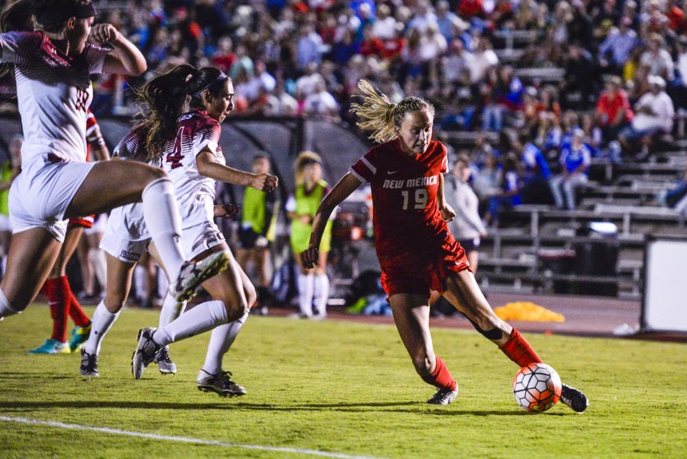 Redshirt midfielder Annie Wheeler fends off New Mexico State defenders as she drives towards the net on Friday, Sept. 16, 2016 at the UNM Soccer Complex.&nbsp;