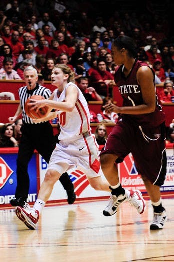 Amy Beggin looks for a teammate in UNM's 80-48 win over NMSU on Thursday at The Pit. Beggin had a season-low four points. 