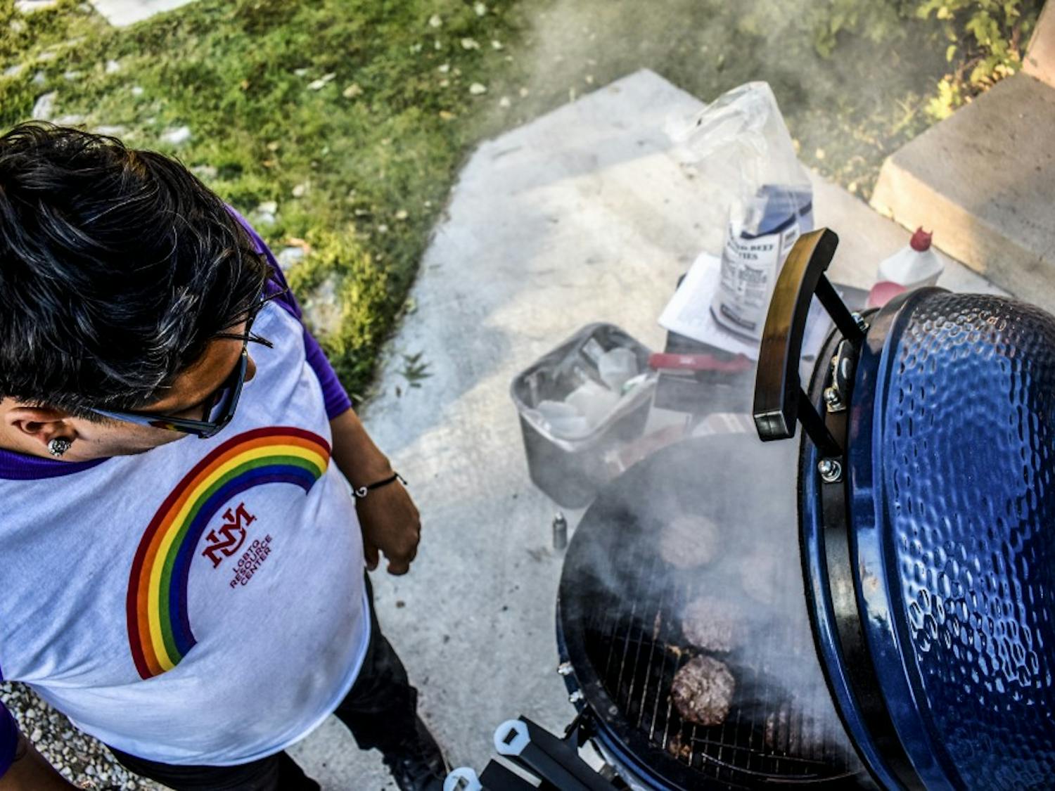 An LGBTQ Resource Center staff member grills to celebrate National Coming Out Day.