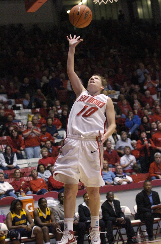 	Amy Beggin lofts up a floater in UNM’s 77-55 win over North Carolina A&amp;T on Friday at The Pit. The Lobos defeated North Carolina A&amp;T to get to the finals of the Midtown Thanksgiving Tournament, where UNM lost to Toledo on Saturday, 62-56