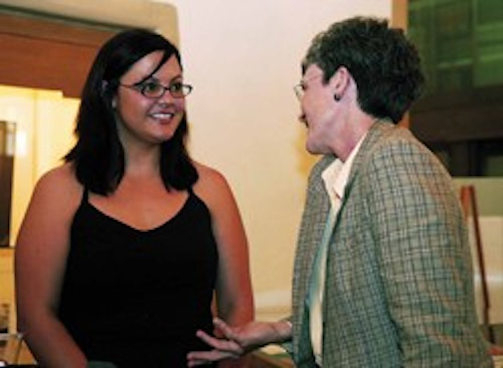 UNM senior Krys Vega, left, talks with Rep. Heather Wilson at a news conference in Zimmerman Library on Friday after she spoke about legislation she sponsored to help get more Hispanics into graduate school.