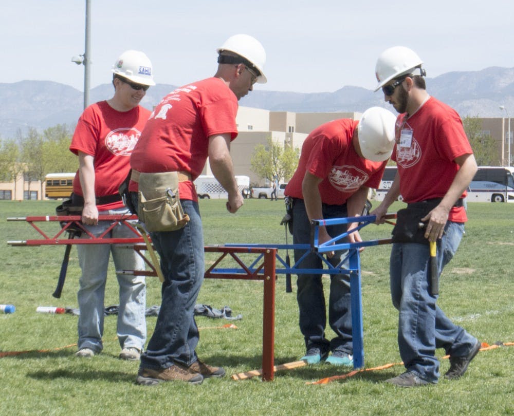 A team at the concrete canoe and steel bridge competition practice assembling their bridge Friday afternoon at Johnson Field. NMSU, took first place of the competition.  