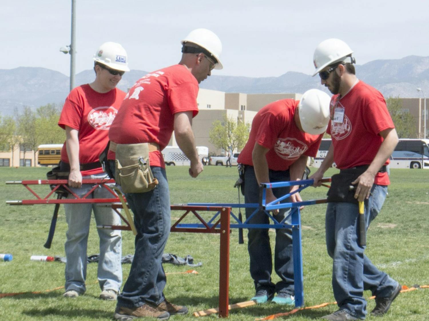 A team at the concrete canoe and steel bridge competition practice assembling their bridge Friday afternoon at Johnson Field. NMSU, took first place of the competition.  

