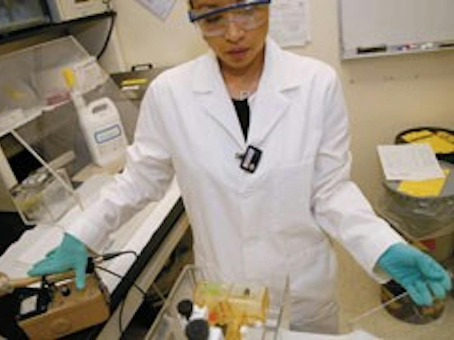 Student Alicia Arguelles moves a glass plate after checking it with a Geiger counter while performing DNA testing in Castetter Hall on Wednesday.