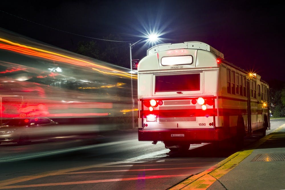 UNM shuttles pass each other Tuesday night at the bus stop on the intersection of Yale Boulevard and Redondo Drive. A new night bus service&nbsp;has been installed this semester&nbsp;to help students safely move from one end of campus to the other when the other shuttles stop running.&nbsp;