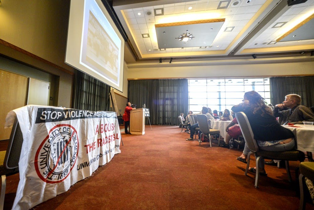 Attendees of a UNM seal forum listen and watch slides about pre-existing seals. This forum took on a different approach by splitting up attendees into small discussion groups.