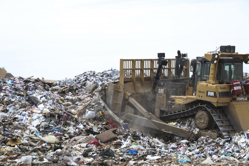 A tractor blows a freshly dumped pile of garbage at the Cerro Colorado Landfill on April 6, 2018.&nbsp;