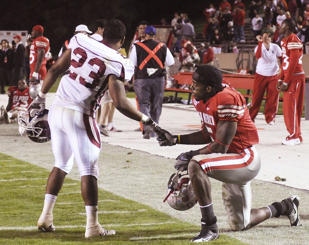 	NMSU’s Tony Glynn comforts Lobo wide receiver Daryl Jones after the Lobos’ disheartening 20-17 loss Saturday. UNM has yet to win a game this season. See the back page for more coverage.