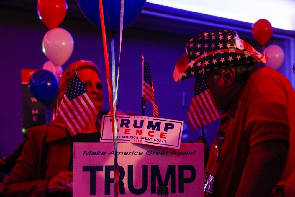 Trump supporters hold signs and flags during the Republican Party watch party on Tuesday, Nov. 8, 2016 at the Albuquerque Convention Center.