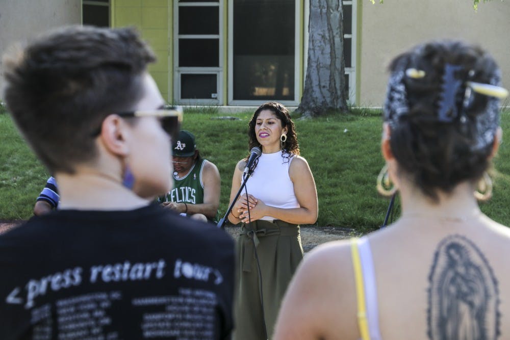 Tannia Esparza, the executive director of Young Women United, speaks with attendees of the Resource Walk and Survivor’s Stand on April 25, 2018.
