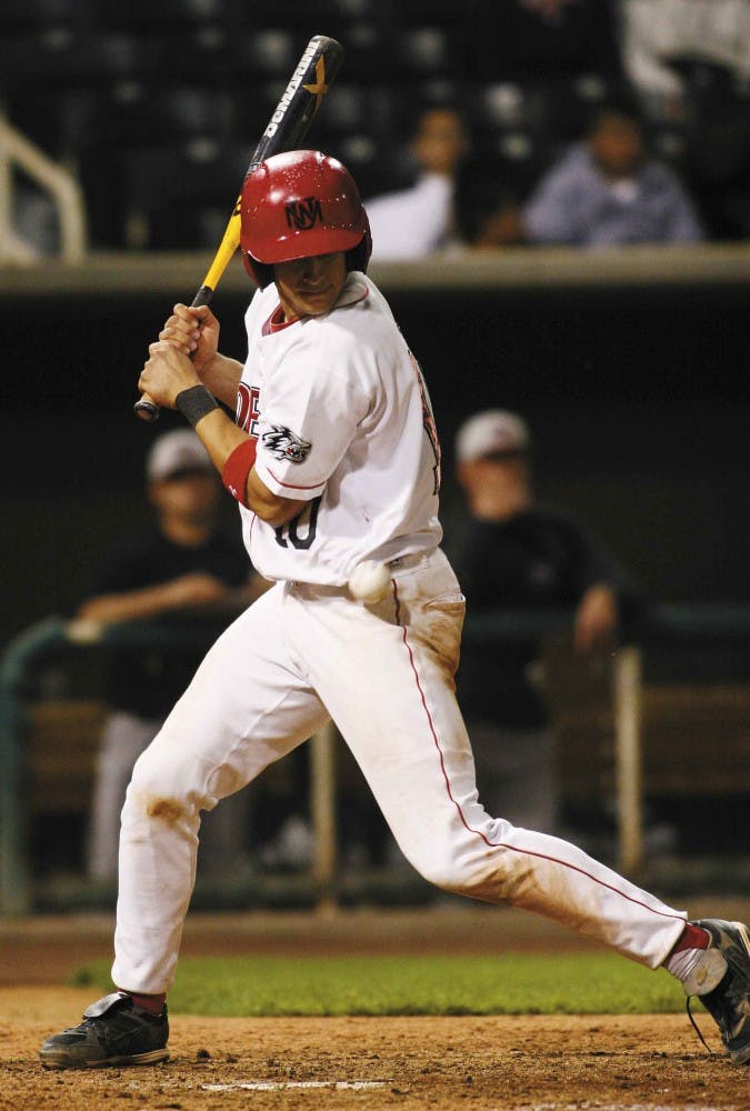 Third baseman Ian Hollick gets hit by a pitch from NMSU's Matt Melendez in the sixth inning of the Lobos' 13-6 win Tuesday against the Aggies at Isotopes Park. 