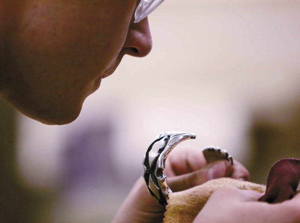 Student Stephan Jochum polishes a silver bracelet made of Precious Metal Clay in the ASUNM Crafts Studio in the SUB on Tuesday. PMC contains microscopic particles of silver or gold suspended in an organic binder that creates a pliable material. When PMC i