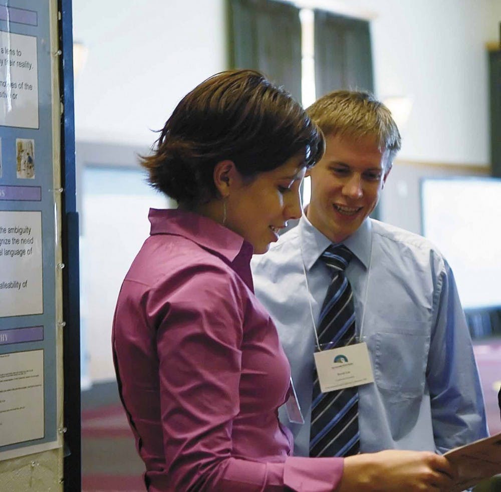 Student Maria DeBlassie, left, talks to Brian Lee, a judge at the Undergraduate Creativity and Research Conference, about her project on author Jane Austen on Tuesday in the SUB. 