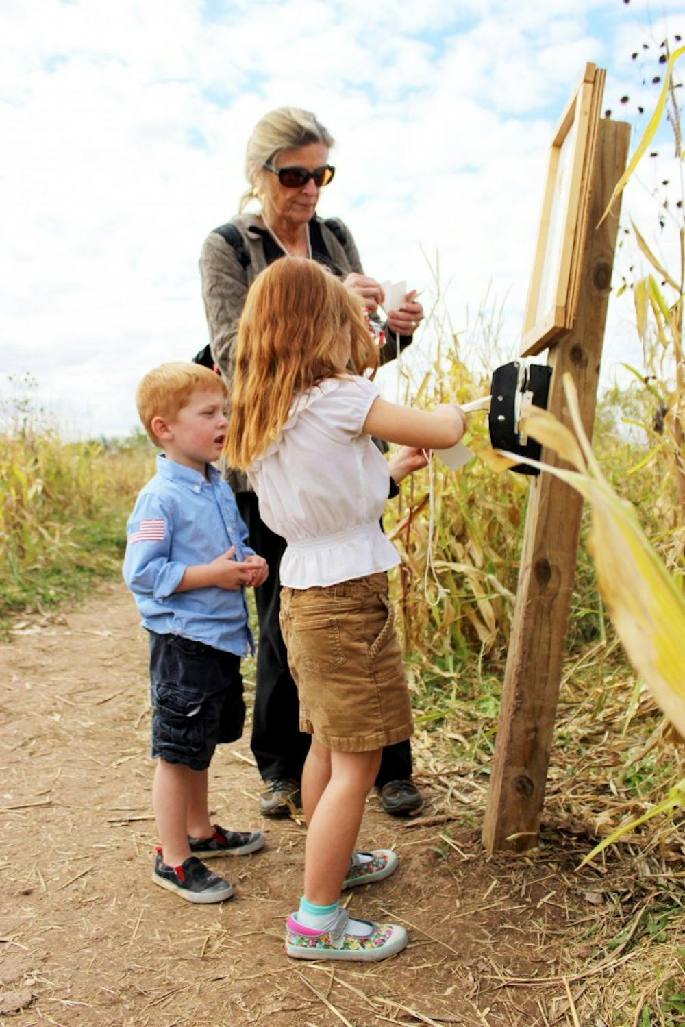 Tommy Cavanaugh (left) and his sister Claire Cavanaugh (right), collect stamps as they navigate Los Poblanos corn maze Saturday, Oct. 24, 2015. Los Poblanos gives a family friendly atmosphere during the Halloween season for people who dont like traditional Halloween activities.