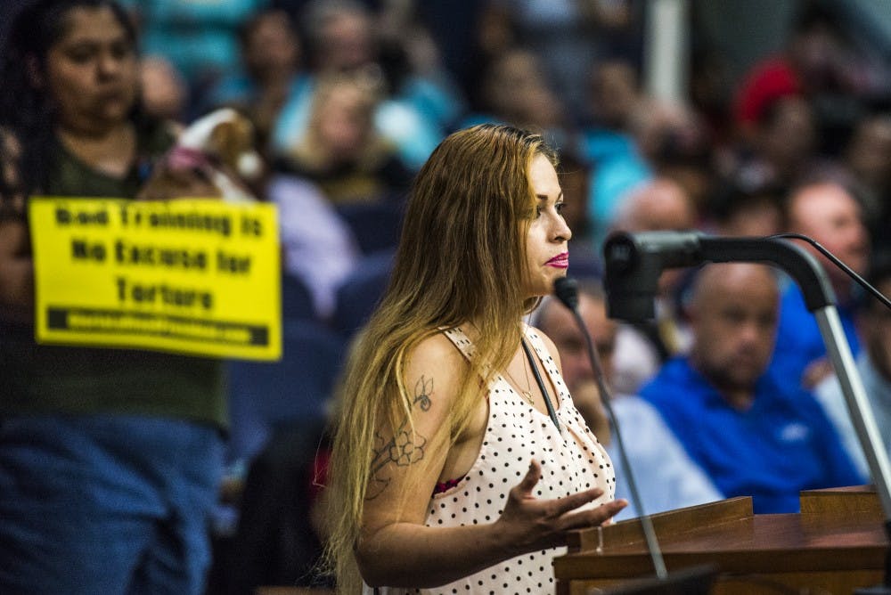 Susie Chavez speaks at the podium during Tuesday night's city council meeting, pleading thta the city fire jail&nbsp;Sgt. Eric Allen from the Metropolitan Detention Center. Chavez was accompanied by several protesters who also stood up and spoke with council members.&nbsp;