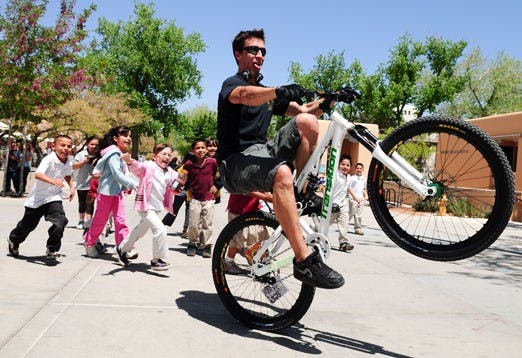 Children from Christine Duncan Charter School chase Karl Lavine as he rides his bike near the SUB on Wednesday. 