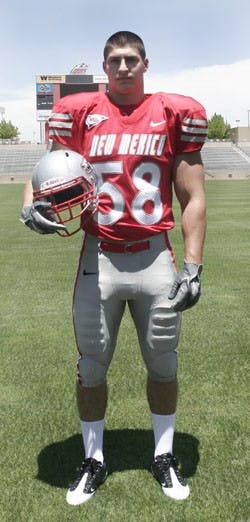Wide receiver Daryl Jones (left) models the Lobos' new uniform during a press conference on Friday. The white jersey and cherry pant combo will be the football team's away uniform.  Carmen Messina (right), posing in the home uniform, said he likes the uni