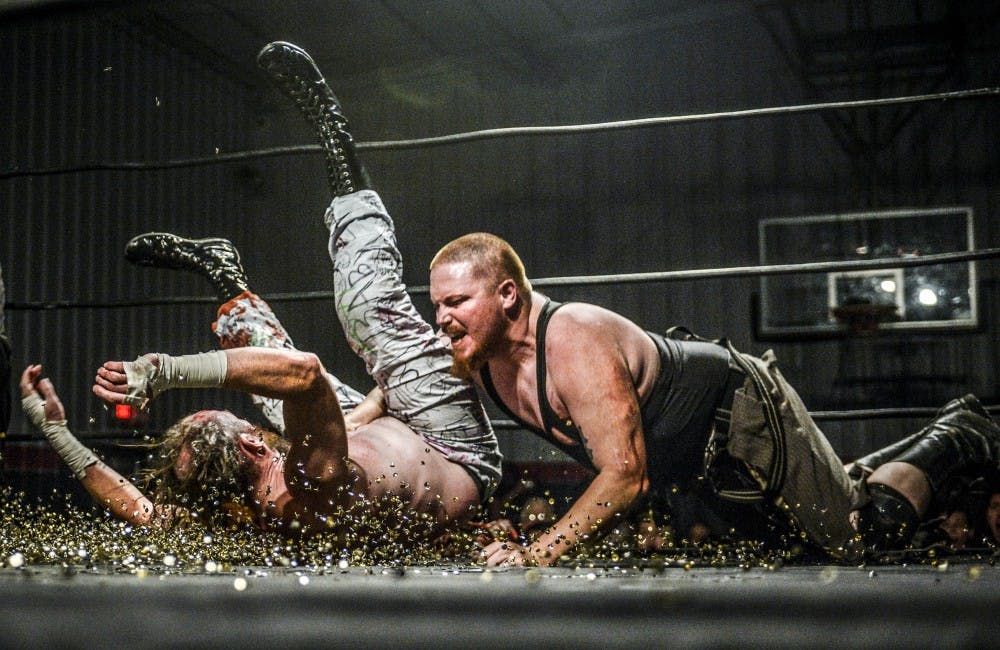 Josh Pain slams Johnny K into a bed of thumb tacks during the Day of Destiny X pro wrestling event held at the Westside Community Center on&nbsp;Oct. 21, 2017
